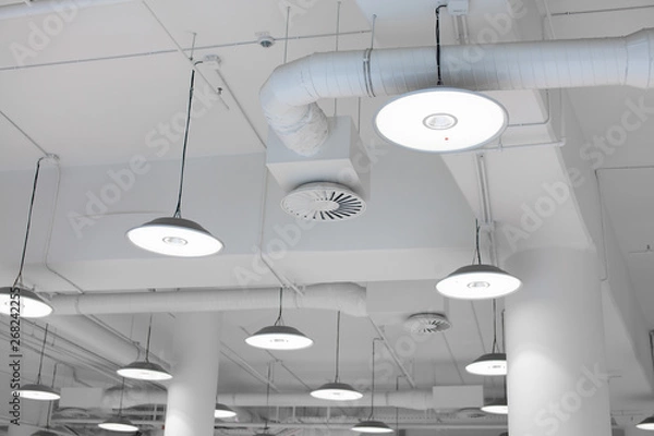 Fototapeta Shopping center led lighting. Ceiling lights in the mall. Ventilation and water pipes. Fire alarm system