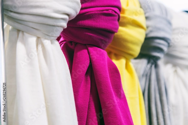 Fototapeta scarves of different colors on the counter in the store