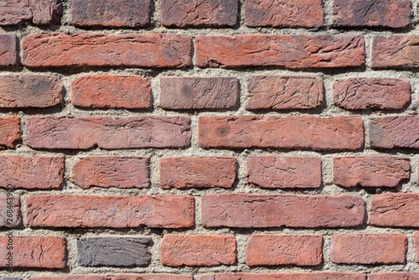 Fototapeta old red brick wall texture close-up background in sunlight