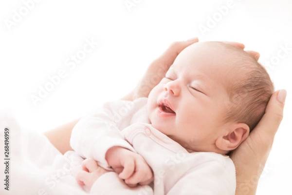 Fototapeta Newborn Baby Sleep on Mother Hands, New Born Girl Smiling and Sleeping, Happy Two Weeks Old Child on White