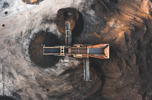 Fototapeta Aerial photo of a vibrating aggregate screen machine with 3 chutes from above, used for screening soil