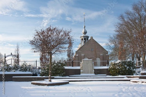 Obraz Old Dutch church with graveyard in winter