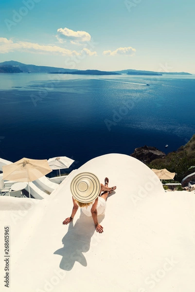 Fototapeta Luxury travel vacation woman looking at view on Santorini island