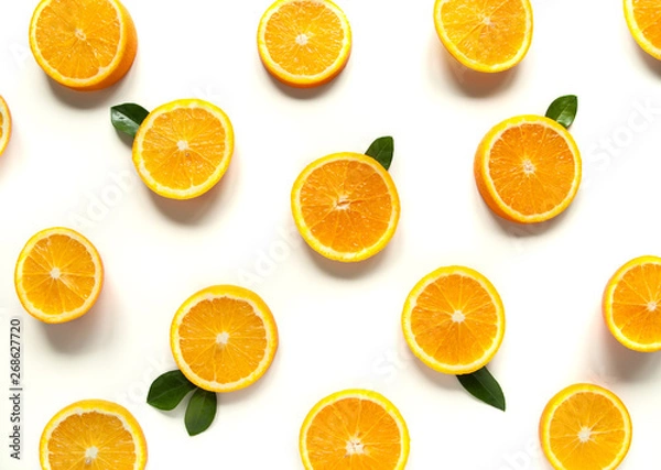 Fototapeta Round orange slices on a white background. Citrus tropical fruit background. Bright food. Dietary vitamin nutrition. A lot of vitamin C.
