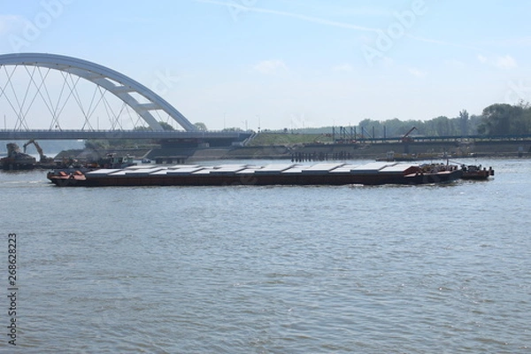 Fototapeta Barges under Zezelj bridge on Danube