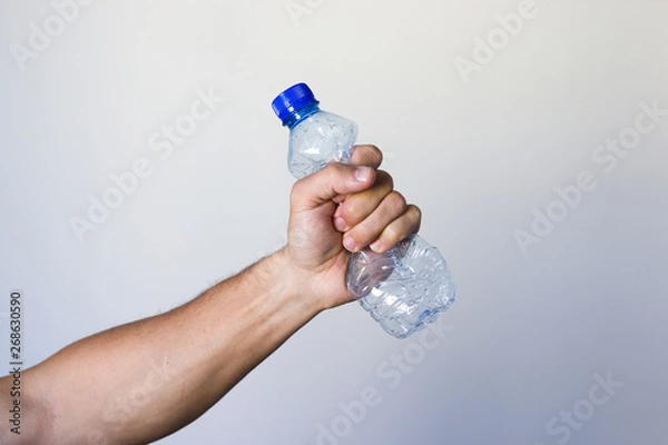 Fototapeta Hand squeezing Plastic Bottle