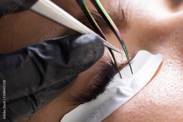 Obraz Eyelash Extension Procedure. Woman Eye with Long Eyelashes. Lashes, close up, macro, selective focus