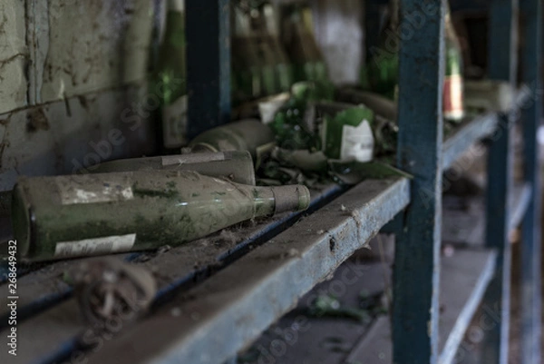Fototapeta Many aged old bottles with wine and sherry in cellar in row. Dusty and dirty