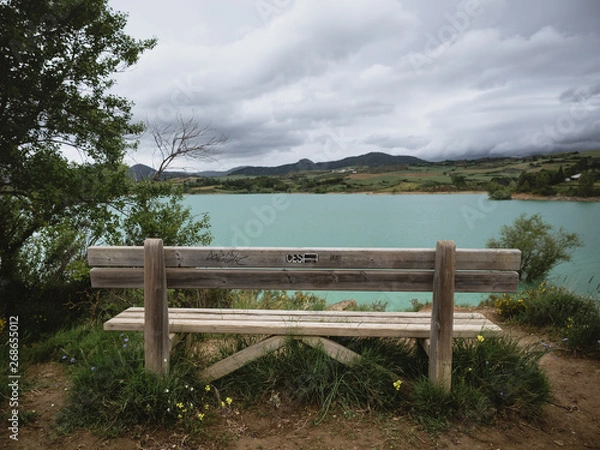 Fototapeta Wooden bench with a view of a flooded land