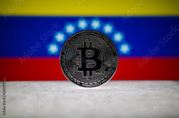 Fototapeta Physical silver version of Bitcoin (BTC) and Venezuela Flag on the background. Conceptual image for investors in cryptocurrency and Blockchain Technology.