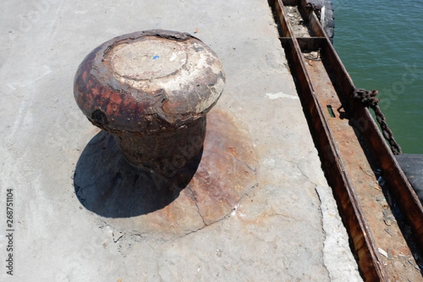 Obraz Rusty mooring bollard with ship ropes