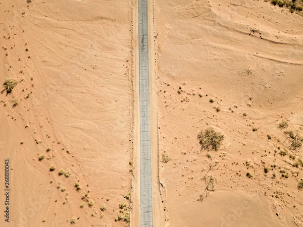 Obraz Old Desert road with cracked asphalt, Top down aerial image.