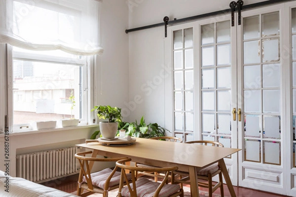 Fototapeta View of a simple bright dinning room