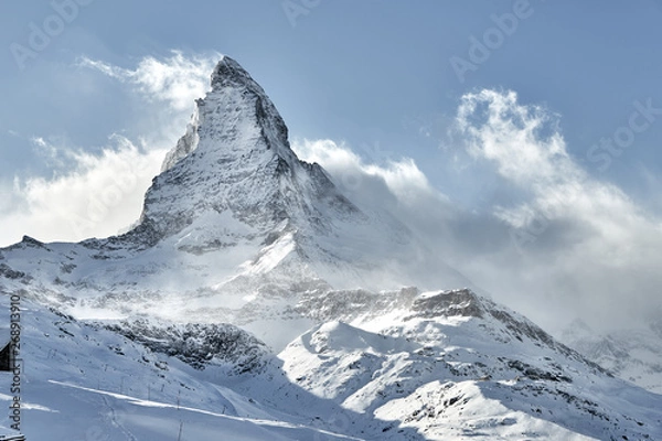 Fototapeta Outstanding  view of Matterhorn covered by clouds with strong wind