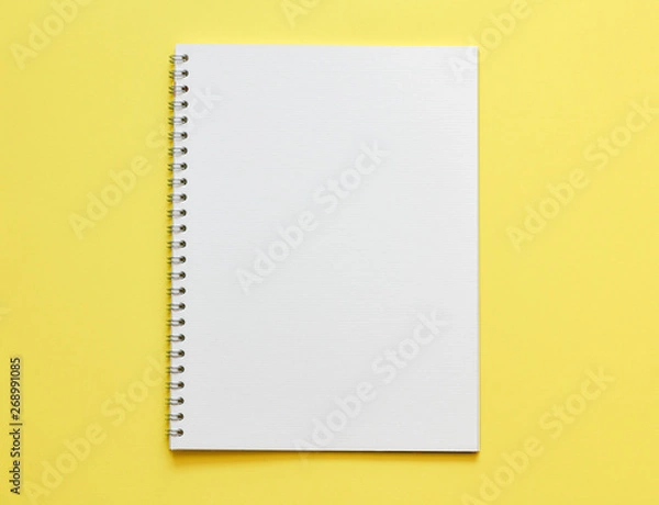 Fototapeta Top view, empty notebook on a yellow background