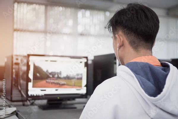 Fototapeta Reaw view Asian Student Male engineers using computer pc for seaching information data internet at technology center room
