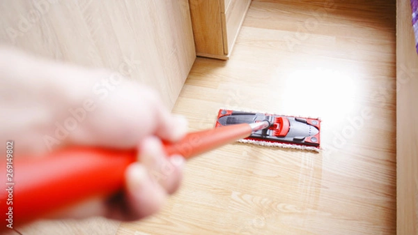 Fototapeta First person view of cleaning home floor with mop