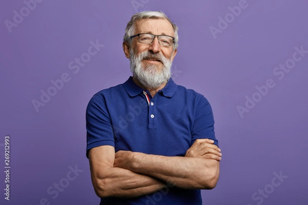Fototapeta happy cheerful man in stylish blue T-shirt with arm crossed rejoicing at his retirement. health, beauty concept. free time, spare time