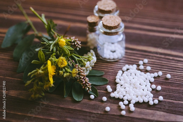 Fototapeta Homeopathic globules in small bottles, homeopathy concept