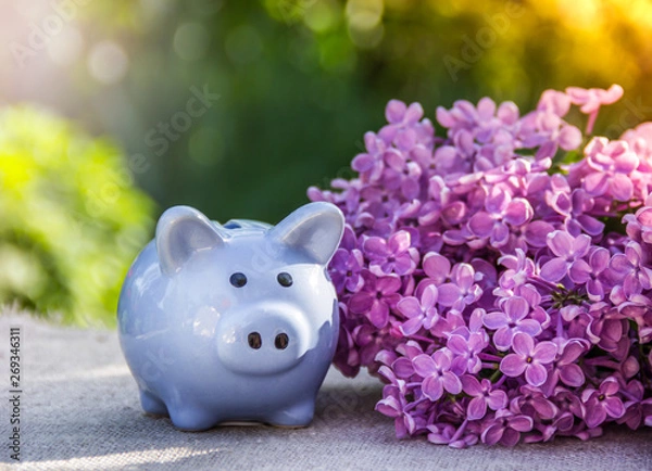 Fototapeta Piggy bank on the table. Blue piggy bank