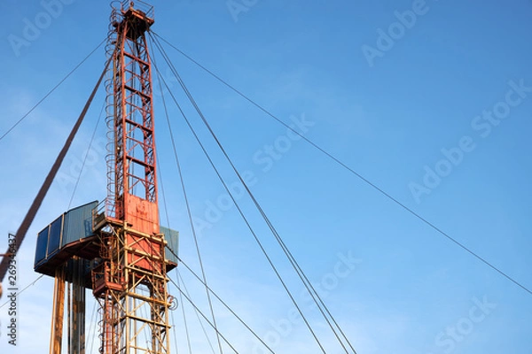 Fototapeta part of the rig in action with pipes in the evening