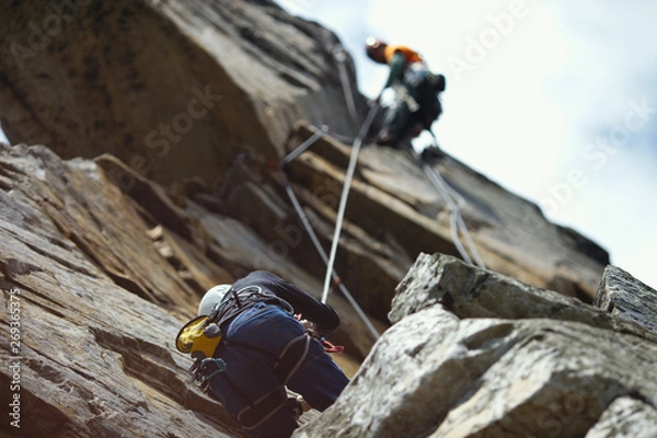 Obraz Abstract image of a two person rope of climbers on a rock tower.