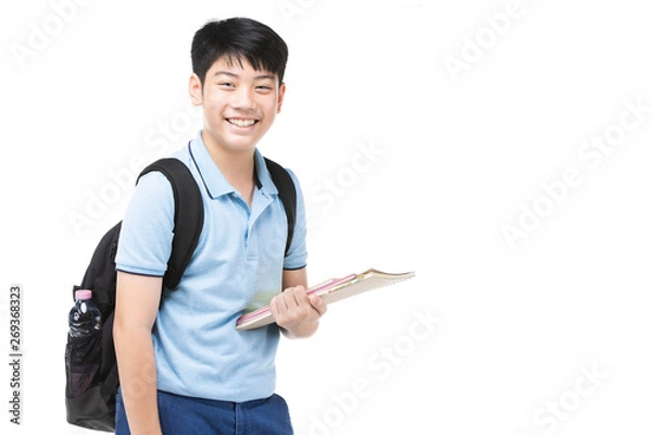 Fototapeta Smiling little student boy in blue polo t-shirt in with books and bag.