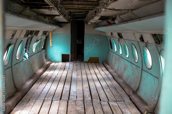Obraz Inside a very old plane. Passenger cabin of a small old plane.