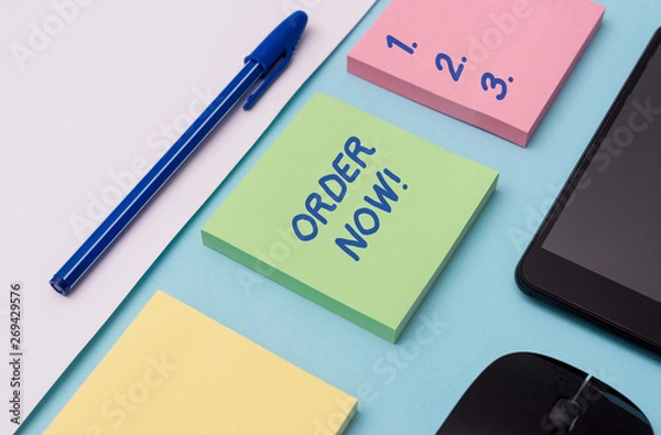 Obraz Handwriting text writing Order Now. Conceptual photo confirmed request by one party to another to buy sell Note papers and stationary plus gadgets placed sideways above backdrop