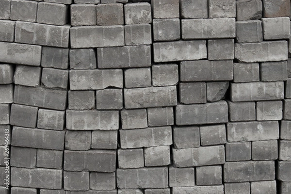 Fototapeta Bricks paving stones on pallets, background texture close-up Cobblestones paving roads, materials for construction