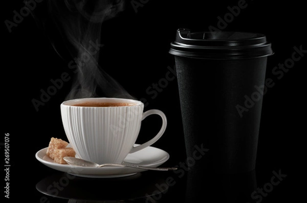 Obraz White cup of coffee and black paper cup for hot drinks on a black background.