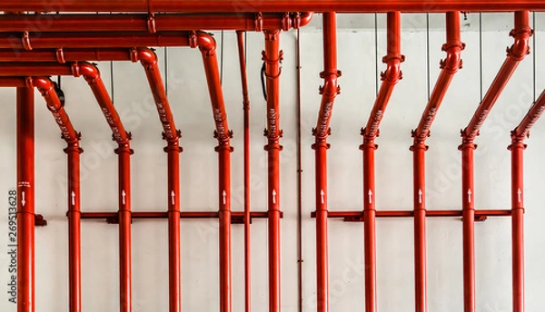 Obraz red color metal pipe on white wall