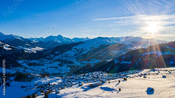 Fototapeta Aerial view of townwith snow covered roofs. Village in Switzerland in winter with a lot of snow