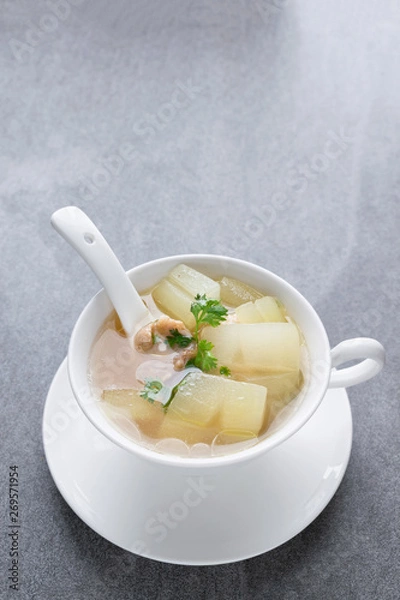 Obraz Boiled winter melon soup with chicken rib in white bowl on table.
