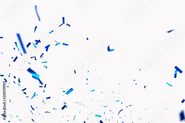 Fototapeta Confetti from crackers. Blue elements on a white background. Shot of confetti at a party. Festive mood. Serpentine, festive decor