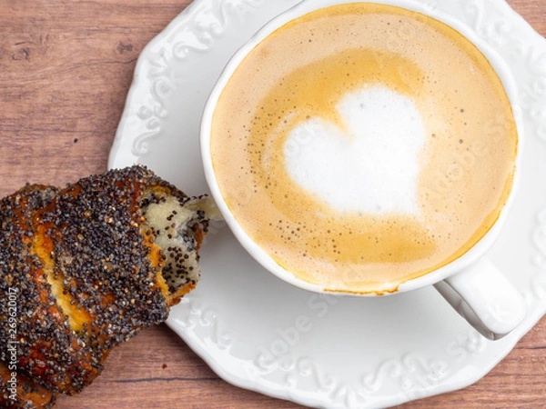 Fototapeta coffee at restaurant cappuccino with a heart shaped froth, croissant