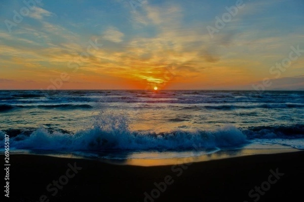 Fototapeta Beautiful sunset at the beach with waves