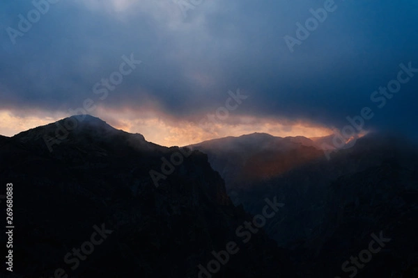 Fototapeta mountain in a cloudy day at sunset with blue sky