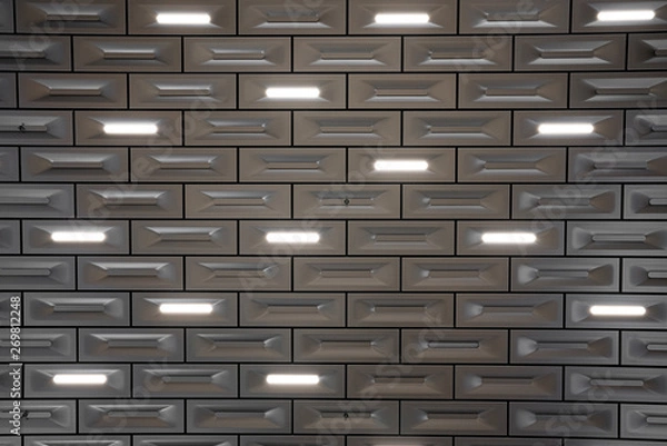 Fototapeta Detail design of aluminium ceiling block in brick pattern with led lighting integrated  in surface / detail aluminium / abstract background texture / architectural design / seamless pattern