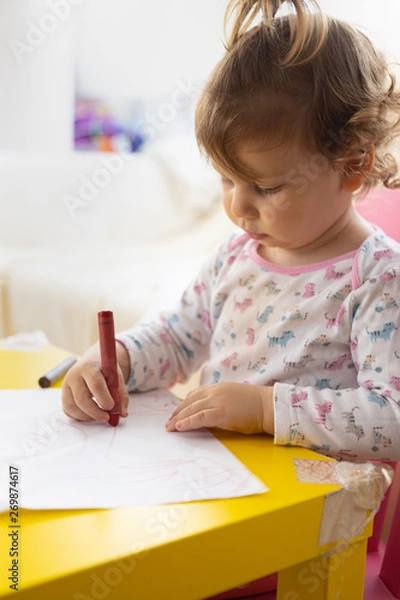 Obraz toddler girl drawing with crayons on paper