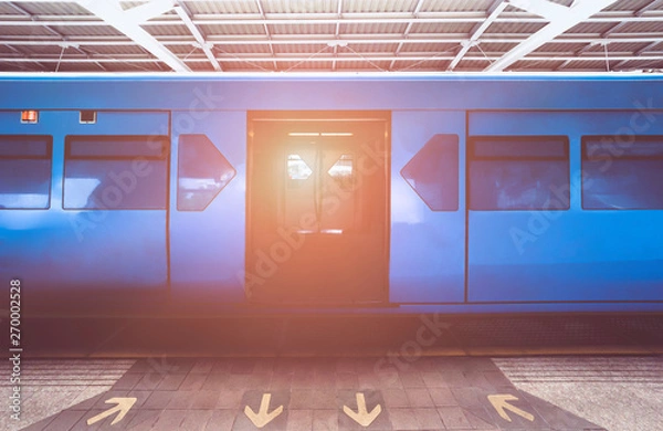Fototapeta blue color Train is open the door while ariving station. Sign get in and go out for BTS sky train on platform
