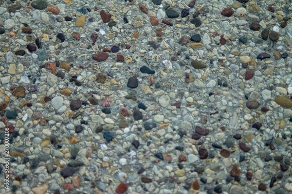 Fototapeta image of pebbles on concrete.
