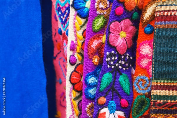 Fototapeta Peruvian traditional colorful native handicraft textile fabric at market in Machu Picchu, one of the New Seven Wonder of The World, Cusco Region Peru, South America. Selective focus, Close up.
