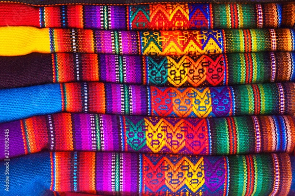 Fototapeta Peruvian traditional colorful native handicraft textile fabric at market in Machu Picchu, one of the New Seven Wonder of The World, Cusco Region Peru, South America. Selective focus, Close up.