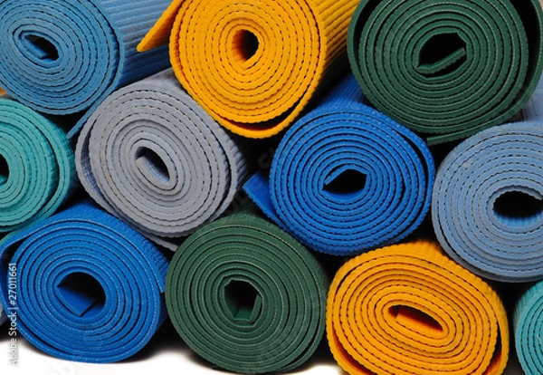 Fototapeta many colorfull yoga mats as a background. isolated on white back