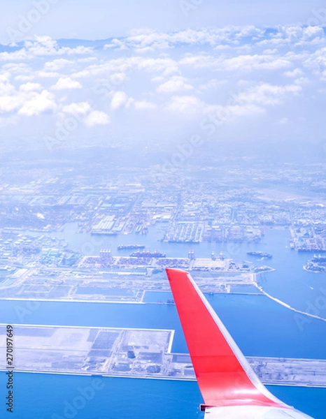 Fototapeta Bussiness and travel concept. Aerial view through window inside aircraft cabin with beautiful blue sky and cloud with sunlight, copy space, top view