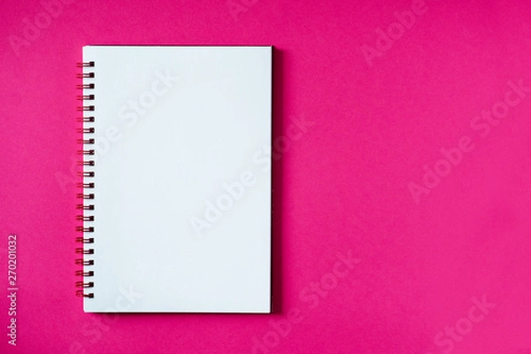 Fototapeta School notebook on a pink background, spiral notepad on a table. Top view copy space, mockup. Office notepad flat lay.