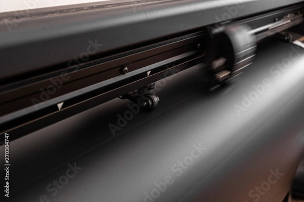 Fototapeta Vinyl cutter plotter machine and moving cutting head