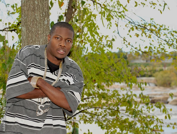 Obraz Young African American man with his arms crossed.