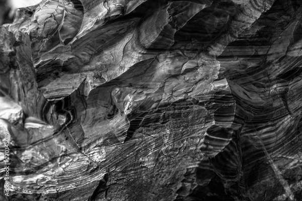 Fototapeta Natural black volcanic stone texture venetian plaster background. Dark volcanic rock venetian plaster stone texture grain pattern. Black grunge charcoal background texture rock